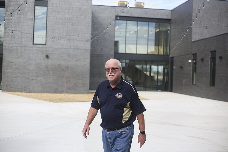 Centerton Mayor Bill Edwards walks a courtyard, Friday, February 11, 2022 at the new City Hall in Centerton. (NWA Democrat-Gazette/Charlie Kaijo)