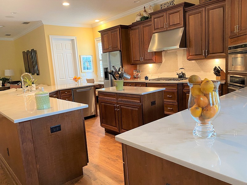 To update this 20-year-old kitchen, we made the high-low counters all one-level, replaced the brown bullnose granite with creamy quartzite counters cut with an eased (or squared) edge, replaced the stainless sink and faucet, and changed out the vintage knobs and pulls. Soon, a new glossy tile backsplash will finish the renovation. (Courtesy of Marni Jameson)