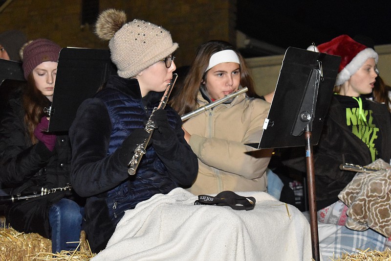 Democrat photo/Garrett Fuller — Sisters Marie Baepler, left, and Emma Baepler practice a song Saturday before the Jamestown Christmas parade.