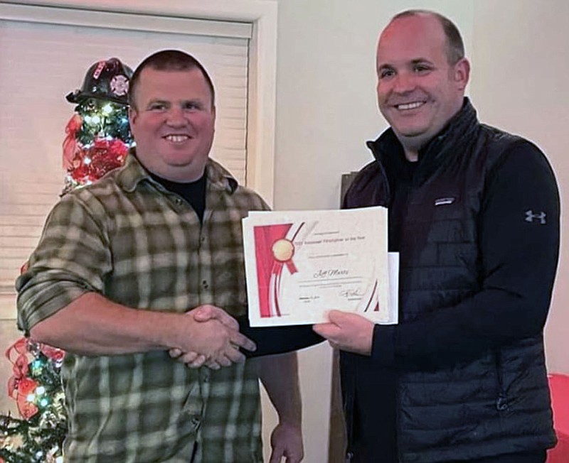 Courtesy photograph
Jeff Marts was named ... at the Pea Ridge Fire-EMS Department Christmas dinner Friday, Dec. 9. Fire Chief Jared Powell presented the certificate to Marts.