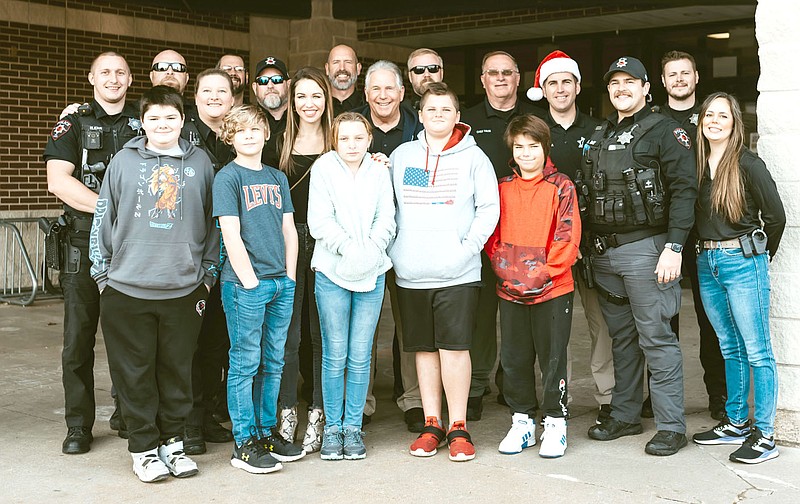 Courtesy photographs
Pea Ridge Police officers took students from Pea Ridge schools Christmas shopping recently for the Shop with a Cop program.