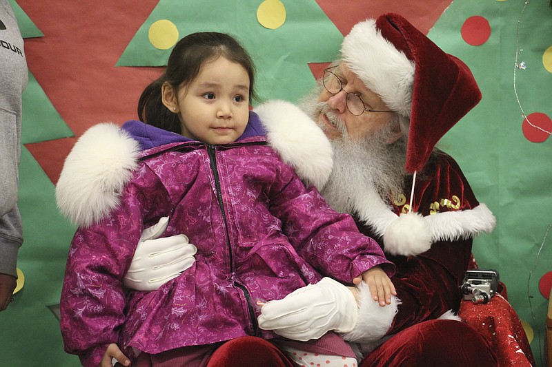 Santa Claus poses with a child Nov. 29 at the Trapper School in Nuiqsut, Alaska. (AP/Mark Thiessen)