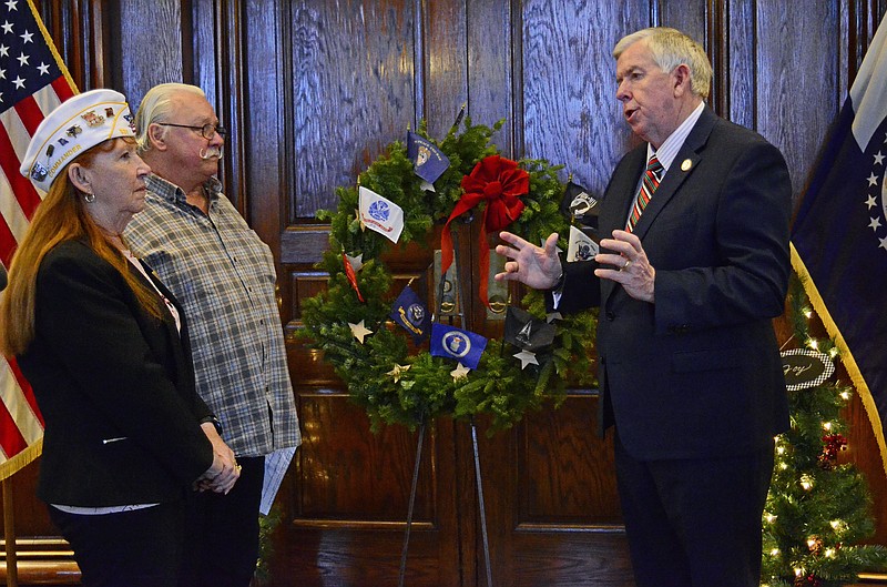 Eileen Wisniowicz/News Tribune photo: 
Governor Mike Parson thanks Rose Noonan, left, and Rick Hirsch for their dedication to the Wreaths Across America organization. The wreath is for the upcoming National Wreaths Across America day on Dec. 17.