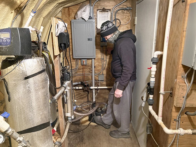 In this Jan. 4, 2022, photo Tim Maye shows a water treatment system in a shed outside his home in Dimock, Pa. Maye says his system, designed to remove gas drilling-related contaminants from his well water, never seemed to work properly. Faulty gas wells drilled by Cabot Oil & Gas were blamed for leaking methane into the groundwater in Dimock, in one of the best-known pollution cases ever to emerge from the U.S. drilling and fracking boom. (AP Photo/Mike Rubinkam)