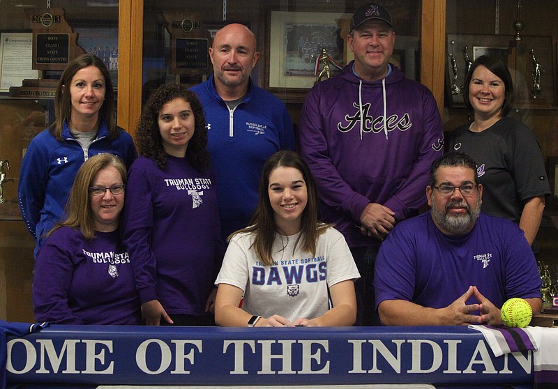 Coombs (front row center) is gathered around family, friends, and coaches at her signing ceremony on Dec. 13. (Democrat photo/Evan Holmes)