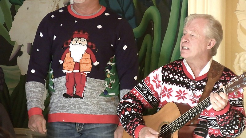 Mike Blackwood plays the guitar while other members of the Fun City Chorus perform during The Salvation Army Red Kettle Kickoff last month. - Photo by Lance Porter of The Sentinel-Record