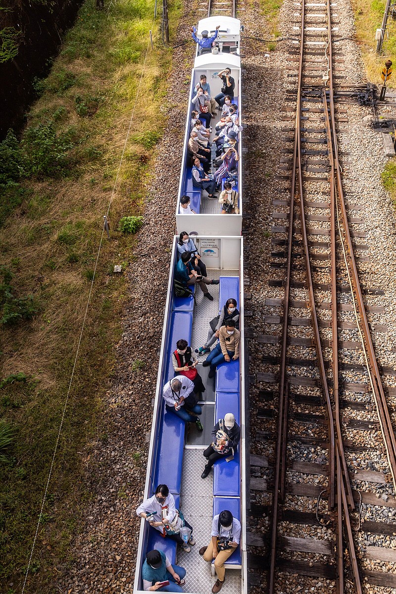 ourists enjoy the Japanese countryside as they ride the Takachiho Amaterasu Railway's sightseeing train. MUST CREDIT: Photo by Shiho Fukada for The Washington Post.