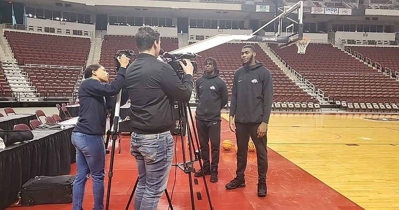 Pine Bluff High School Zebras junior Courtney Crutchfield (left) and senior Jordan Harris talk Thursday to Little Rock television reporters to promote the upcoming King Cotton Holiday Classic in Pine Bluff. (Pine Bluff Commercial/Suzi Parker