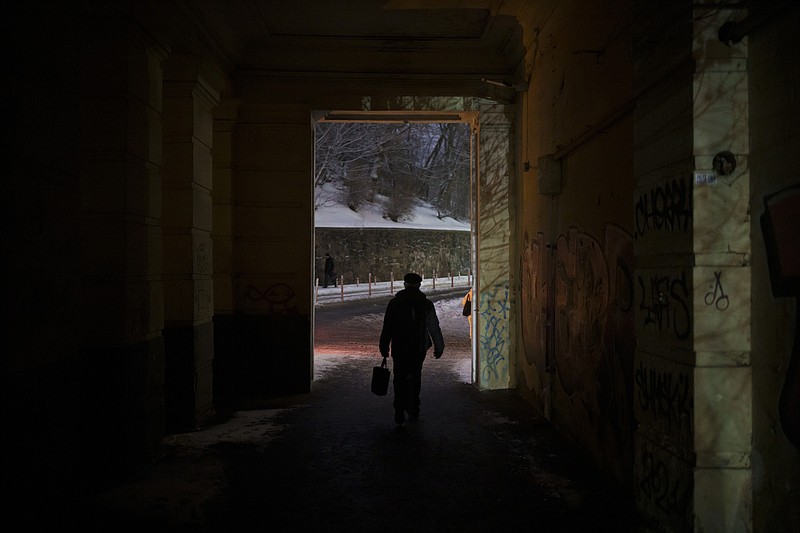 A man walks during a power outage in Kyiv, Ukraine, Thursday, Dec. 15, 2022. (AP Photo/Felipe Dana)