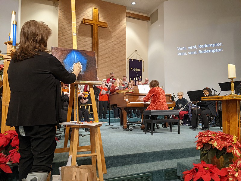 Ryan Pivoney/News Tribune photo: 
Janis Burgin paints a nativity scene live as Our Savior's Singers and a chamber orchestra perform "Advent Cry" during The Winter Rose and Christmas Cantata Dec. 18, 2022, at Our Savior's Lutheran Church in Jefferson City.