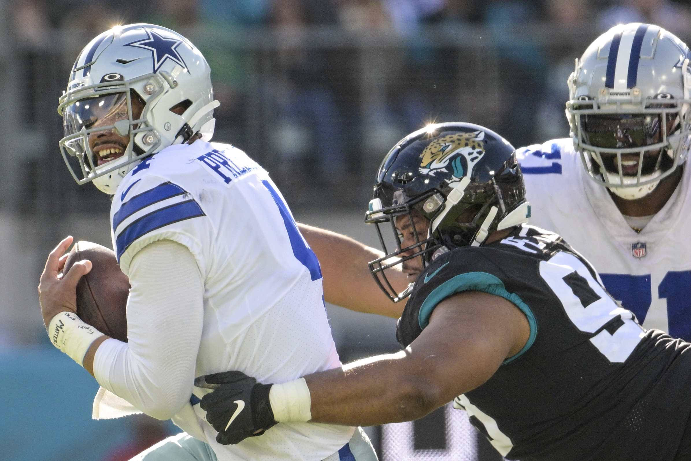 Dallas Cowboys running back Rico Dowdle (23) fumbles the ball against  Jacksonville Jaguars cornerback Gregory Junior (34) during the first half  of an NFL preseason football game, Saturday, Aug. 12, 2023, in