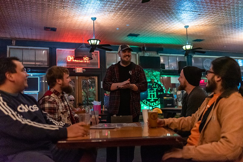 Christian Mackey, manager of Hopkins, mingles with guests at Hopkins Ice House in Downtown Texarkana, Arkansas on Thursday, December 15, while artist Chace Rains performs to raise funds to record his first album. (Staff photo by Erin DeBlanc)