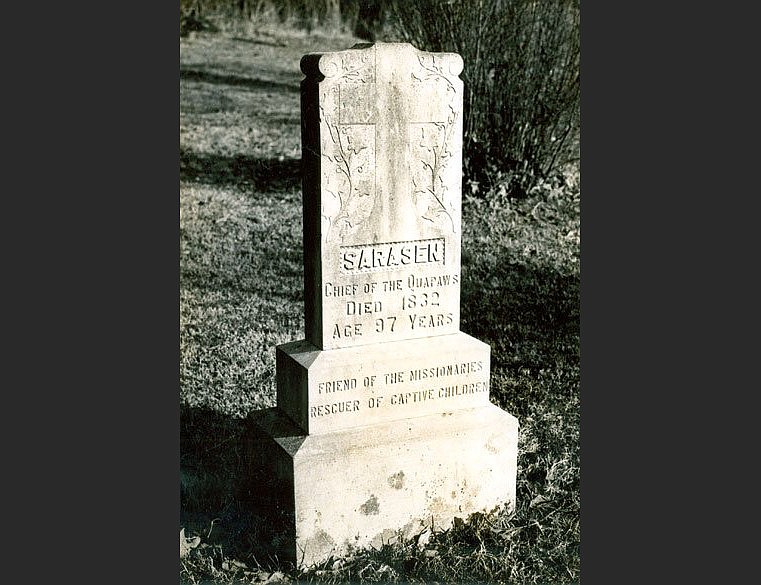 The tombstone of Quapaw leader Sarasin (also spelled “Saracen,” “Sarasen,” or “Sarrasin”) at St. Joseph’s Catholic Cemetery in Pine Bluff (Jefferson County); circa 1975. (Courtesy of the Butler Center for Arkansas Studies, Central Arkansas Library System)