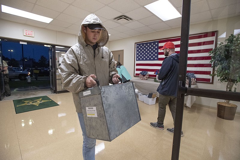 Election worker Jacob Todd of Rogers carries a box of ballots Tuesday May 24, 2022 at the Washington County Sheriff’s office in Fayetteville.  (NWA Democrat-Gazette/J.T. Wampler)