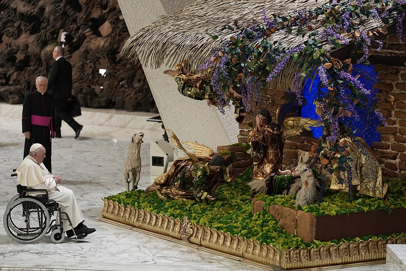 Pope Francis looks at a nativity scene as he leaves after his weekly general audience in the Paul VI Hall on Wednesday, Dec. 21, 2022, at the Vatican. (AP Photo/Andrew Medichini)