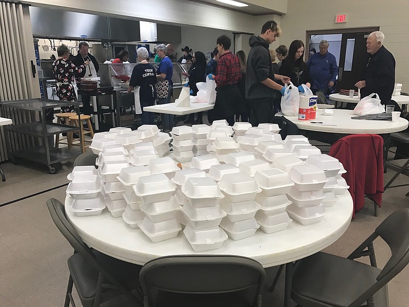 Several Central Christian Church members and volunteers prepare stacks of takeout Christmas meals Sunday, Dec. 25, 2022, at the church in Texarkana, Texas. In all, the church served about 275 meals. (Staff photo by Greg Bischof)