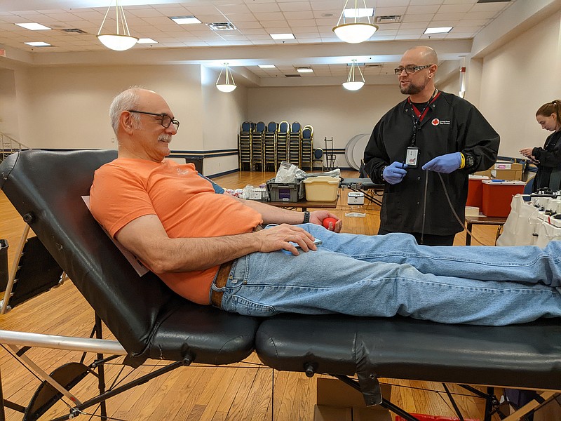 Ryan Pivoney/News Tribune photo: 
Denis Gladbach stretches his arm to donate blood as Jesse Egbert with the American Red Cross prepares the collection instruments Tuesday, Dec. 27, 2022, at the Governor Office Building in Jefferson City.