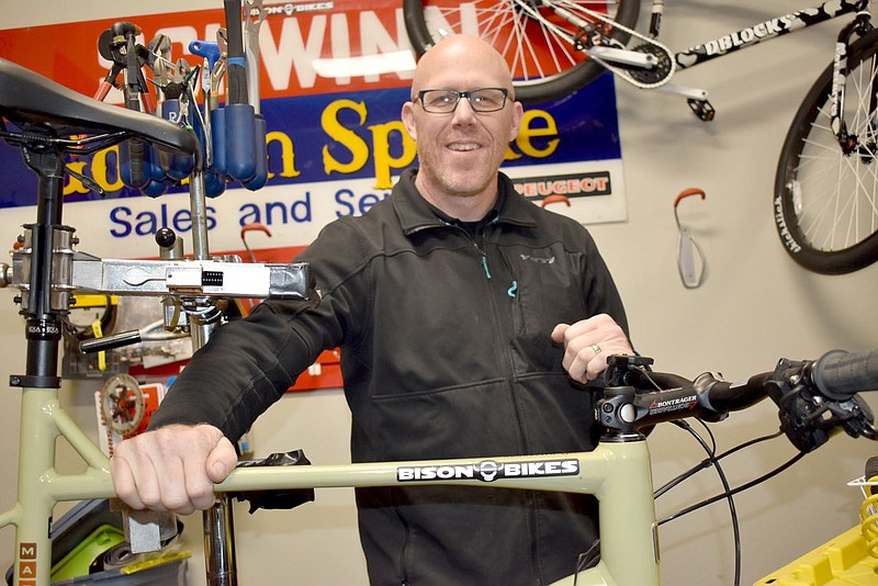 Kendall McCann of Bison Bikes is pictured at his shop on Forest Hills Boulevard. He and his family moved to Bella Vista from California in search of a better life.

(NWA Democrat-Gazette/Rachel Dickerson)