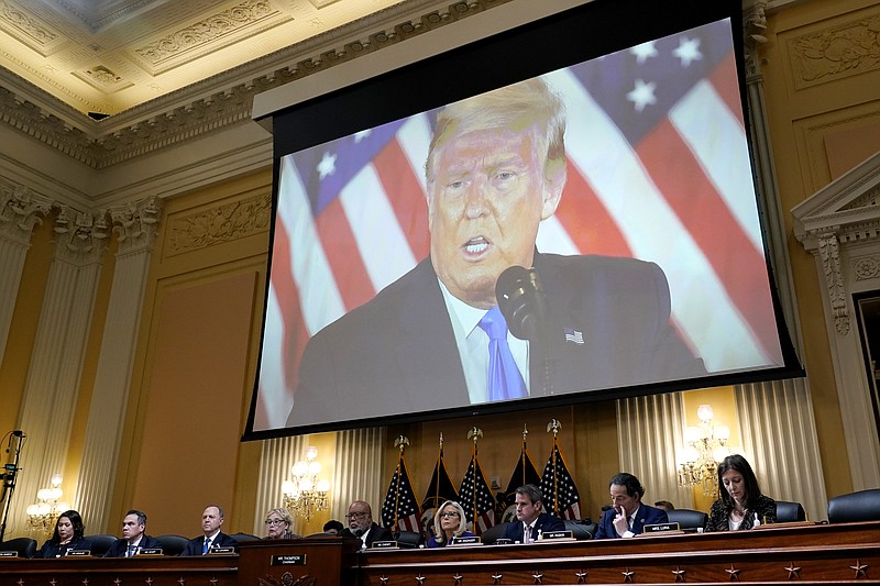 FILE - A video of former President Donald Trump is shown on a screen, as the House select committee investigating the Jan. 6 attack on the U.S. Capitol holds its final meeting on Capitol Hill in Washington, Dec. 19, 2022. From left to right, Rep. Stephanie Murphy, D-Fla., Rep. Pete Aguilar, D-Calif., Rep. Adam Schiff, D-Calif., Rep. Zoe Lofgren, D-Calif., Chairman Bennie Thompson, D-Miss., Vice Chair Liz Cheney, R-Wyo., Rep. Adam Kinzinger, R-Ill., Rep. Jamie Raskin, D-Md., and Rep. Elaine Luria, D-Va. (AP Photo/J. Scott Applewhite, File)