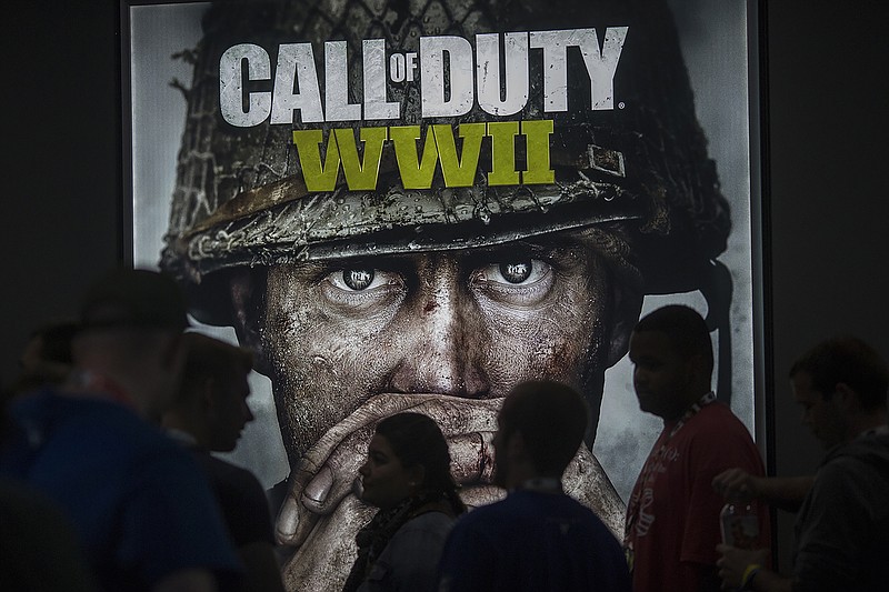 People wait in line of to see a demonstration Call of Duty WWII at the Activision exhibit on opening day of the Electronic Entertainment Expo (E3) at the Los Angeles Convention Center on June 13, 2017, in Los Angeles.  (David McNew/Getty Images/TNS)
