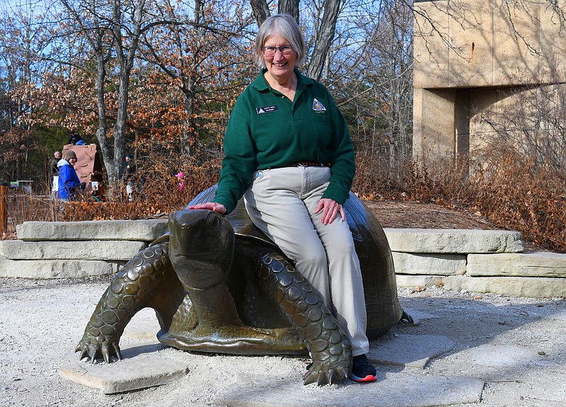 Eileen Wisniowicz/News Tribune photo: 
Judith Deel pats a turtle statue on the head while posing for a photo outside Runge Nature Center in Jefferson City. Deel said she enjoys volunteering at Runge and teaching children about conservation work.