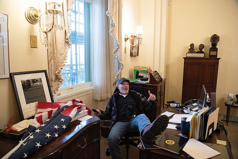 Richard “Bigo” Barnett sits Jan. 6 inside the office of U.S. Speaker of the House Nancy Pelosi inside the U.S. Capitol in Washington, D.C.
(Special to the Arkansas Democrat Gazette)