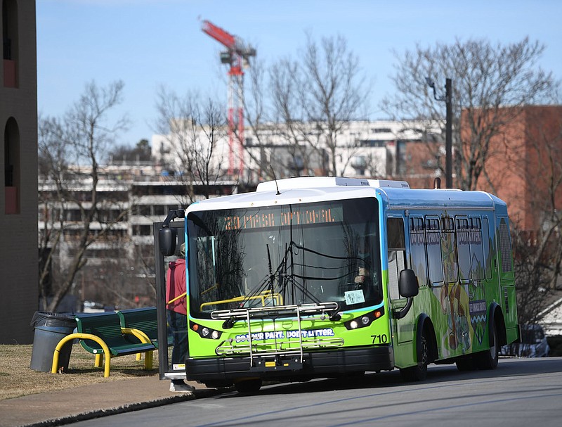 An Ozark Regional Transit bus waits Friday, Dec. 30, 2022, at a timed stop at Hillcrest Towers in downtown Fayetteville. Ozark Regional Transit plans to make some improvements to bus stops in 2023. Visit nwaonline.com/photo for today's photo gallery. 
(NWA Democrat-Gazette/Andy Shupe)