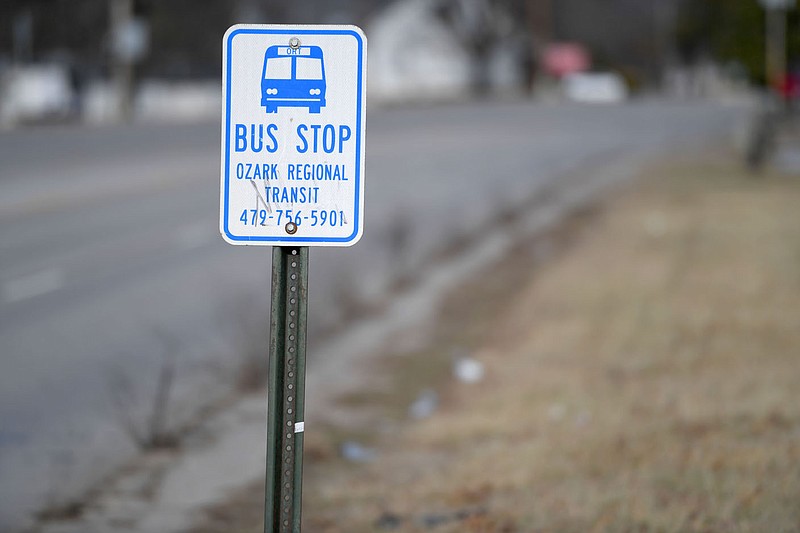 A sign marks an Ozark Regional Transit bus stop Friday, Dec. 30, 2022, on School Avenue in south Fayetteville. Ozark Regional Transit plans to make some improvements to bus stops in 2023. Visit nwaonline.com/photo for today's photo gallery. 
(NWA Democrat-Gazette/Andy Shupe)