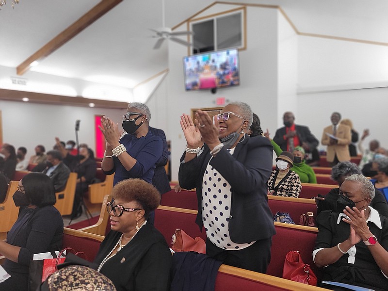 Yvonne Humphrey (standing on the right) and Gloria Tillman of the Jefferson County Assessor's Office react during Monday's Emancipation Proclamation Program presented by the Pine Bluff Branch of the NAACP. The event was held at Eighth Avenue Missionary Baptist Church in Pine Bluff. (Special to The Commercial/Kim Jones Sneed)