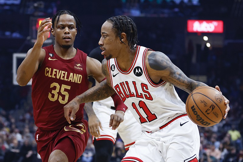 Chicago Bulls forward DeMar DeRozan (11) drives against Cleveland Cavaliers forward Isaac Okoro (35) during the first half of an NBA basketball game, Monday, Jan. 2, 2023, in Cleveland. (AP Photo/Ron Schwane)