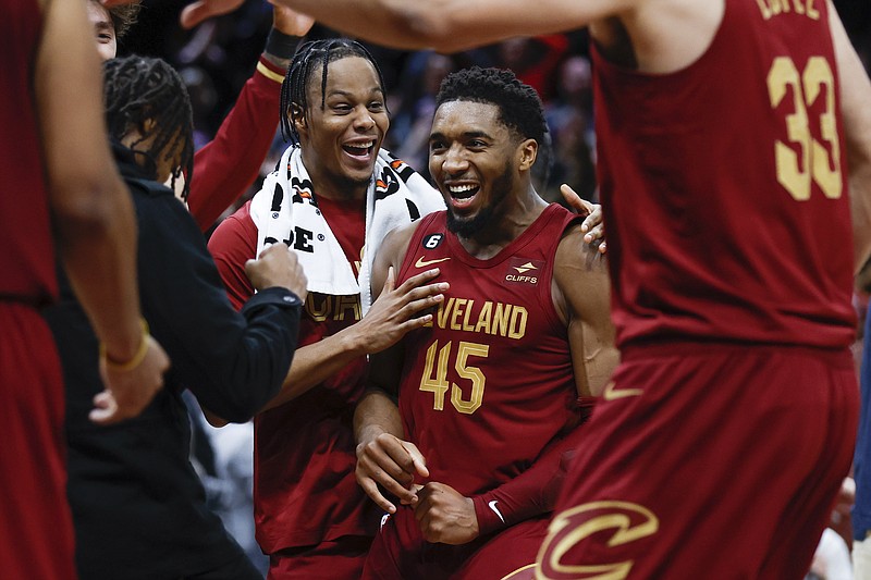 Cleveland Cavaliers guard Donovan Mitchell (45) celebrates with teammates after making a basket to tie an NBA basketball game during the second half against the Chicago Bulls, Monday, Jan. 2, 2023, in Cleveland. (AP Photo/Ron Schwane)