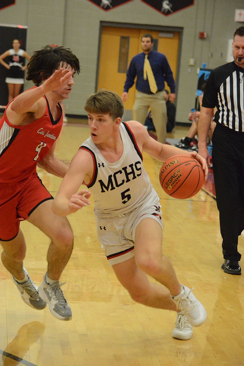 BENNETT HORNE/MCDONALD COUNTY PRESS McDonald County's Cross Dowd, shown here driving against Carl Junction Monday night, was named to the all-tournament team of the Neosho Holiday Classic held Dec. 28-30 at Neosho. The senior guard averaged 18.3 points and 4.3 3-pointers over the three games played by the Mustangs in the classic.