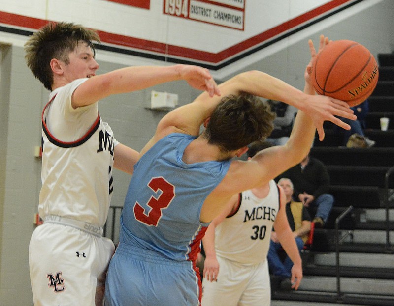 BENNETT HORNE/MCDONALD COUNTY PRESS Webb City's Joe Adams (3) is fouled by McDonald County's Sterling Woods during the game won by Webb City, 55-49, Tuesday night at Mustang Arena.