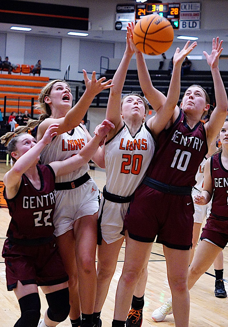 Westside Eagle Observer/RANDY MOLL
Emma Tevebaugh (left), Dalacie Wishon, Graci Moffit and Shelby Still all reach for a rebound during play between Gentry and Gravette in Lion Arena on Jan. 3.
