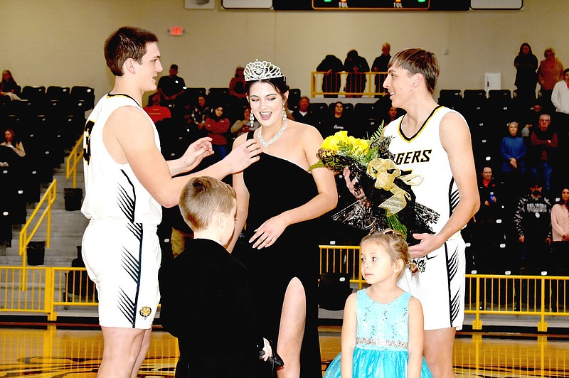 Mark Humphrey/Enterprise-Leader
Prairie Grove senior Kenleigh Elder is crowned 2023 Colors Day queen by co-captain senior Corbin Bowlin (left), while co-captain senior Brandon Bowlin presents flowers with attendants, Darby Guenther and Kyra Vinson, participating in the coronation ceremony Friday at Tiger Arena.