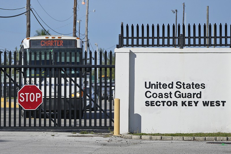 Buses carrying Cuban migrants leave from U.S. Coast Guard Sector Key West, Thursday, Jan. 5, 2023, in Key West, Fla. Homeland Security officials said 337 migrants were taken Thursday by Coast Guard cutter from Dry Tortugas National Park on a 70-mile trip to Key West for processing. (AP Photo/Wilfredo Lee)