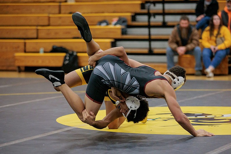 A Fulton boys wrestler sprawls with an Osage wrestler in the Fulton Tri Thursday evening at Fulton High School in Fulton. (Courtesy/Shawley Photography)