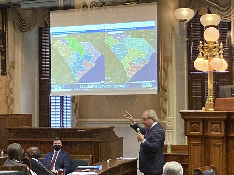 FILE - State Sen. Dick Harpootlian, D-Columbia, compares his proposed map of U.S. House districts drawn with 2020 U.S. Census data to a plan supported by Republicans on Thursday, Jan. 20, 2022, in Columbia, S.C. A panel of federal judges ruled South Carolina lawmakers illegally used race as the main factor to redraw the state's 1st Congressional District. (AP Photo/Jeffrey Collins, File)