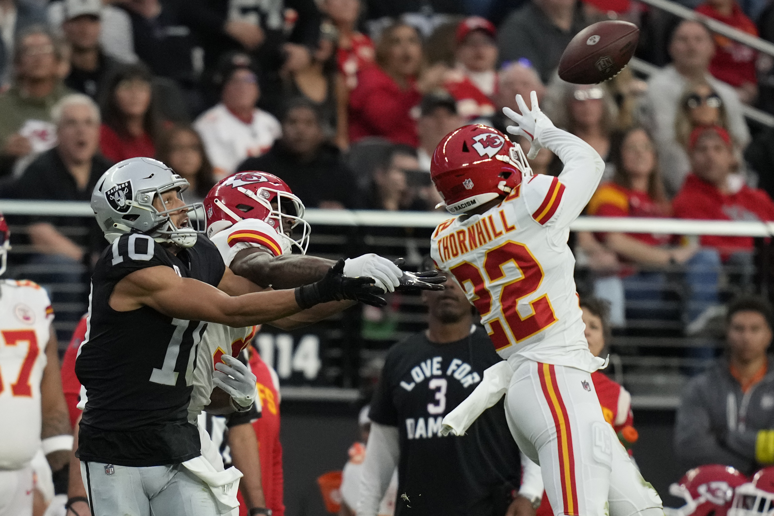 Raiders quarterback Derek Carr (4) is sacked by Kansas City Chiefs  cornerback L'Jarius Sneed (3 …