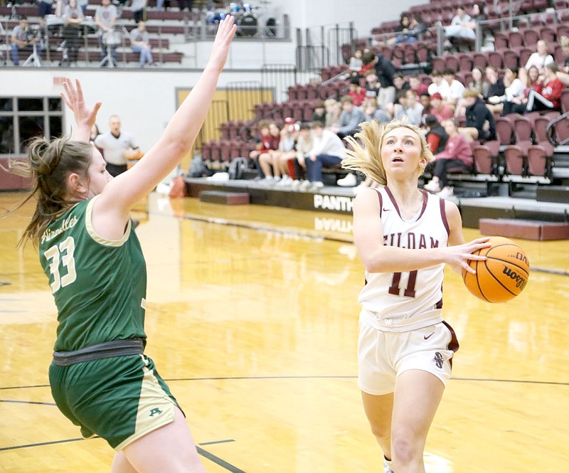 Mark Ross/Special to the Herald-Leader
Siloam Springs senior Cailee Johnson drives in for a shot as Alma's Jordan Gramlich (left) defends on the play.
