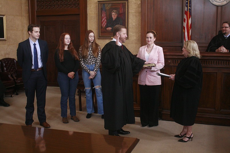 New 13th Circuit, Division 4 Judge Jim Andrews, surrounded by his family, was sworn in Monday by Arkansas Supreme Court Justice Barbara Webb. (Matt Hutcheson/News-Times)