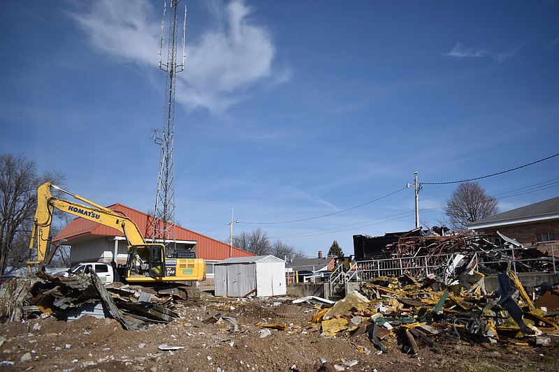 Democrat photo/Garrett Fuller — Piles of debris are all that's left Monday (Jan. 9, 2023,) of the former Moniteau County Jail at North Oak and East North streets. The facility, which was replaced by the current jail in 2013 and later vacated by the Moniteau County Sheriff's Office in 2018, was leveled to make room for a possible addition to the Moniteau County Emergency Dispatch facility, located in the background on the left.