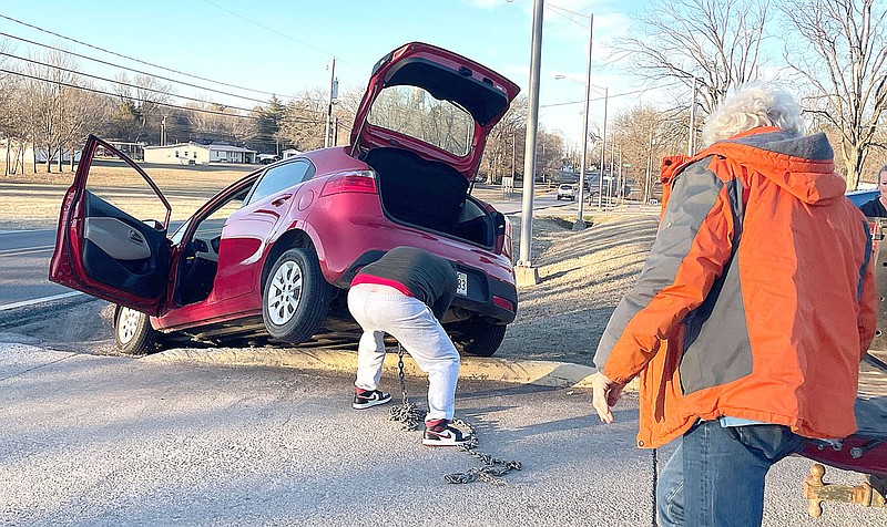 TIMES photograph by Annette Beard
Several people stopped to help ... when her car ran off the driveway into the ditch in front of the post office on North Curtis Avenue Tuesday, Jan. 9, 2023.