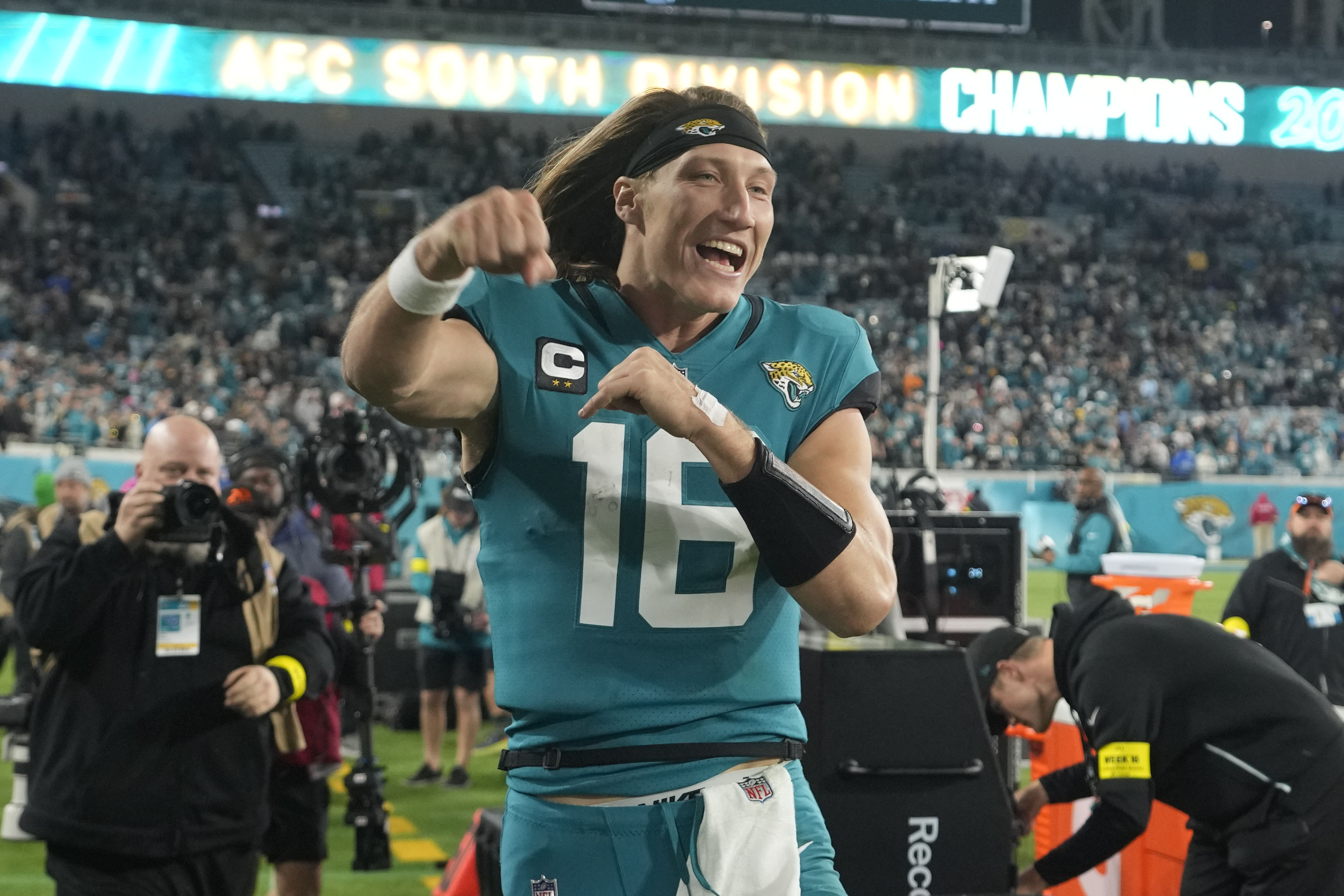 Miami Dolphins fans cheer from the stands during the AFC playoff