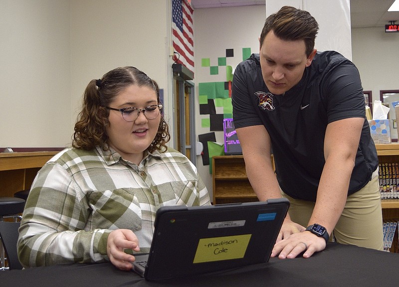 Lake Hamilton School District Director of Communications and Public Relations Brian Bridges shows senior Madison Cole how to use the new TutorMe program during advisory period on Wednesday. - Photo by Donald Cross of The Sentinel-Record