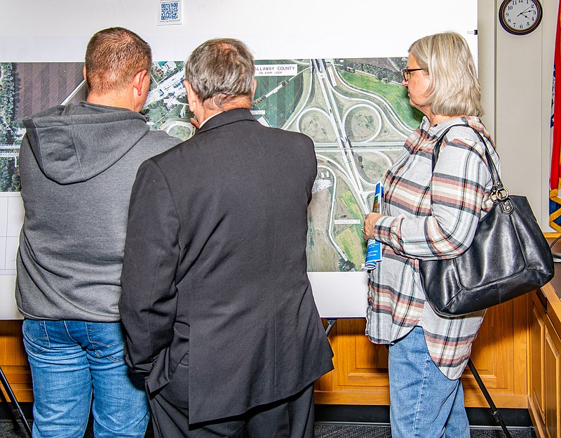 Jason Leubbering with Cole County Industries, State Representative Dave Griffith, and North Jefferson City resident Sharon Anderson discuss MoDOT's proposed changes to US 54 north of the bridge Tuesday at Jefferson City Hall.  (Ken Barnes/News Tribune)
