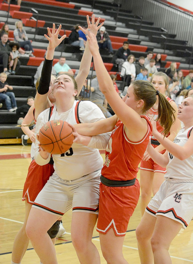 BENNETT HORNE/MCDONALD COUNTY PRESS
Roslyn Huston fights to put up a shot during her team's 41-32 victory Tuesday night against Reeds Spring at Mustang Arena.