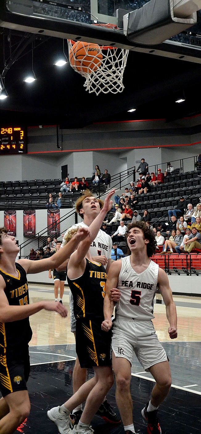 TIMES photograph by Annette Beard
Blackhawks Bric Cates, No. 5, and Ben Wheeler, No. 1, exult over another basket. The Pea Ridge Blackhawks defeated the Prairie Grove Tigers 68-45 Tuesday, Jan. 10, 2023, in Blackhawk Arena.