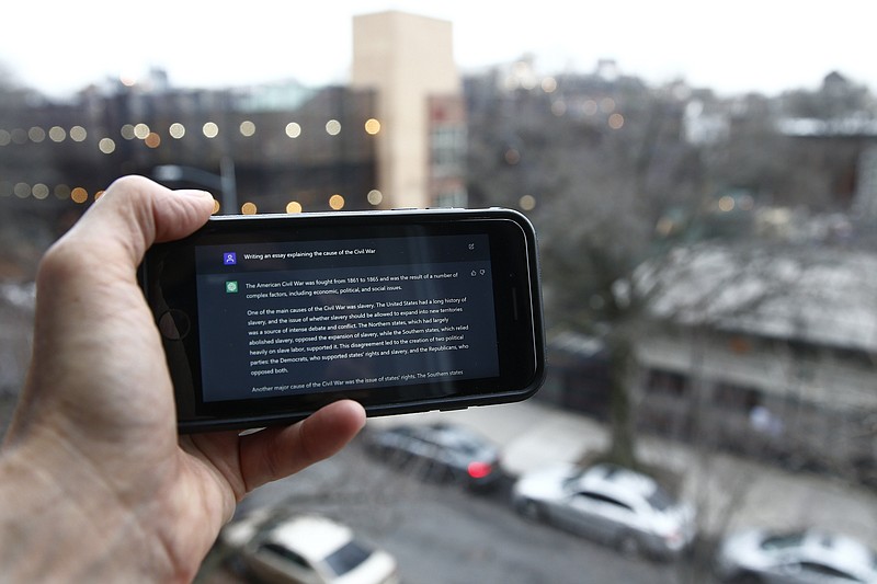 A ChatGPT prompt is shown on a device near a public school in Brooklyn, N.Y. New York school officials started blocking the impressive but controversial writing tool that can generate paragraphs of human-like text. (AP Photo/Peter Morgan)