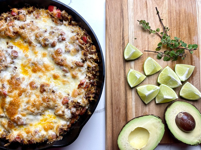 Cheesy Beef, Bean and Rice Skillet served with avocado, limes and fresh oregano. (Arkansas Democrat-Gazette/Kelly Brant)